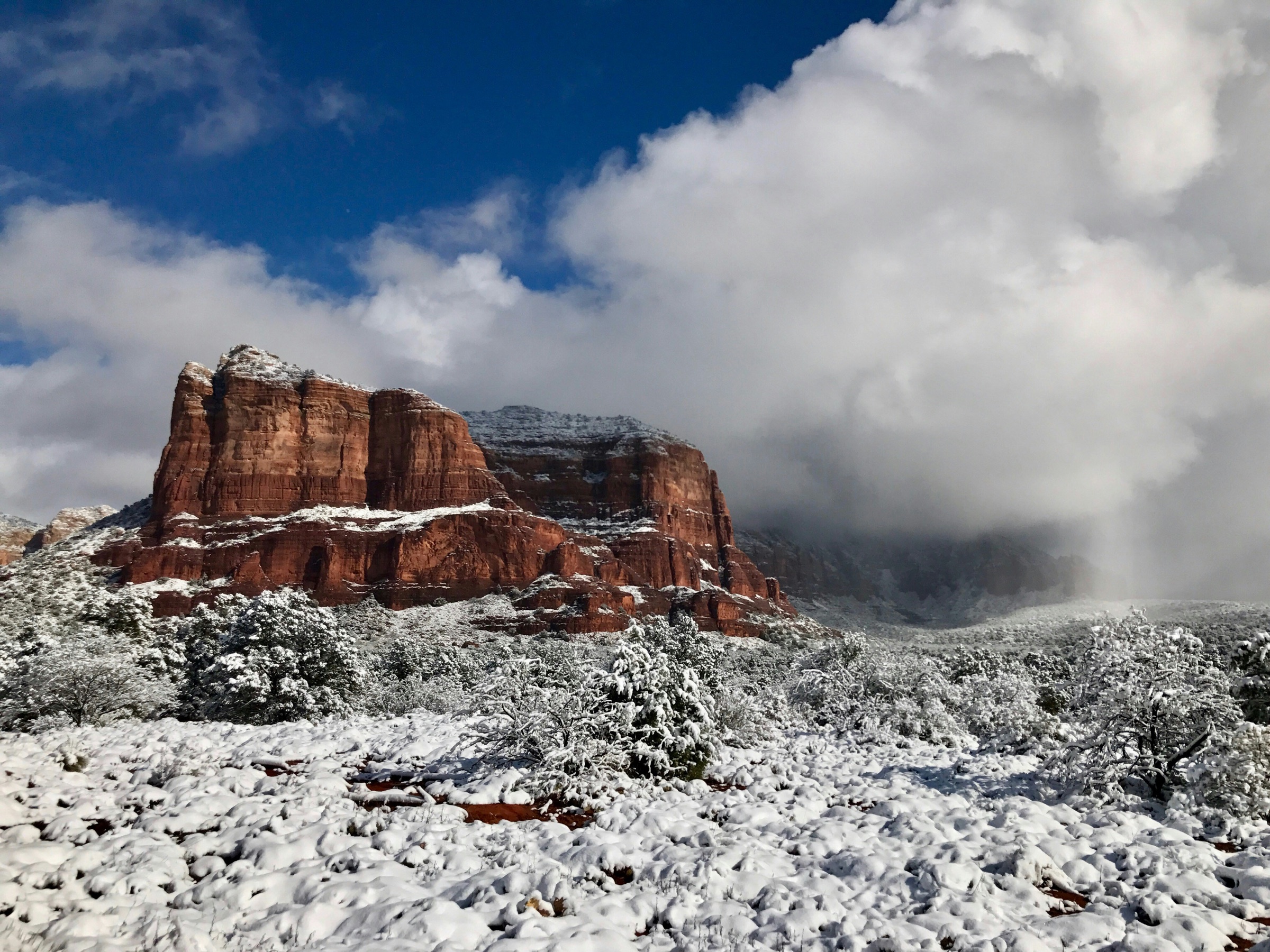 Light snow on the red rocks of Sedona under a dramatic sky