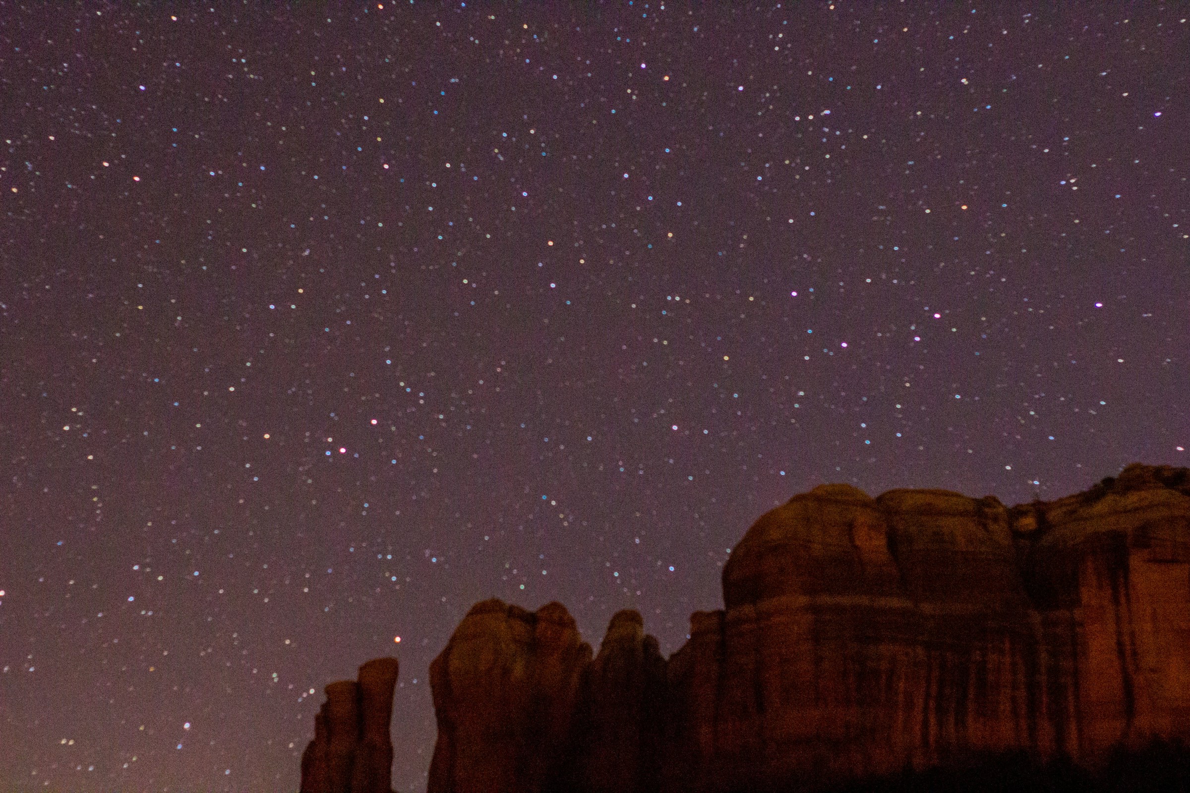 Dense star field above a red rock formation resembling Cathedral Rock
